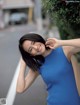 A woman in a blue dress posing for a picture.