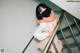 A woman wearing a face mask standing on a stairwell.