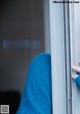 A woman's hand is peeking out of a window.