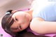 A young girl laying on a purple yoga mat.